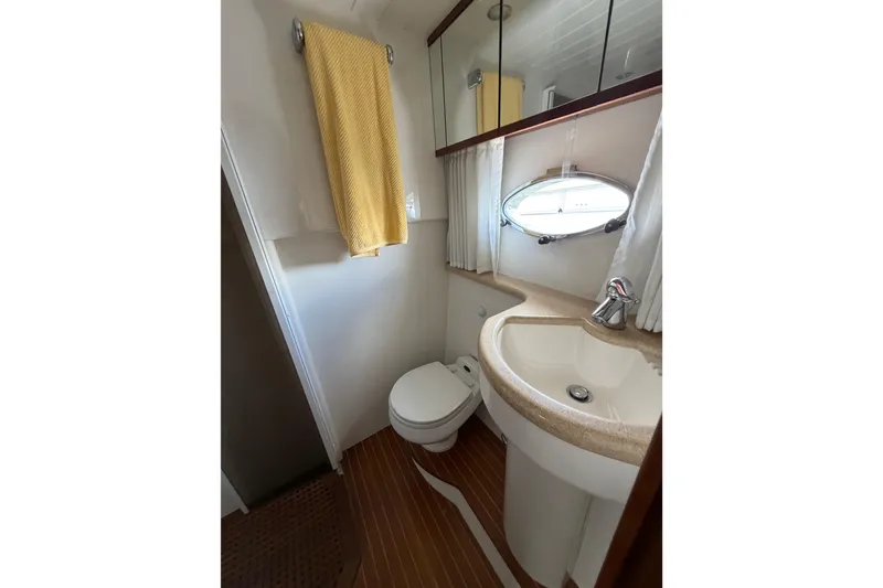 Slide: The Image of Bathroom interior of 2003 Viking Princess V50 yacht with sink, toilet, and mirror. - 15