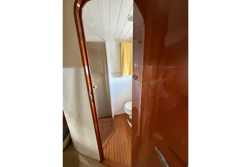 Slide: The Image of Bathroom interior of 2003 Viking Princess V50 yacht with wooden accents and towel. - 16