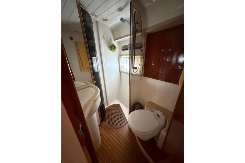 Slide: The Image of Bathroom interior of 2003 Viking Princess V50 yacht, featuring shower and toilet. - 17