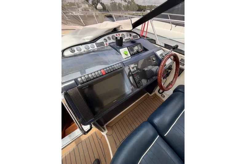 Slide: The Image of Cockpit of 2003 Viking Princess V50 yacht with navigation controls and wooden steering wheel. - 18
