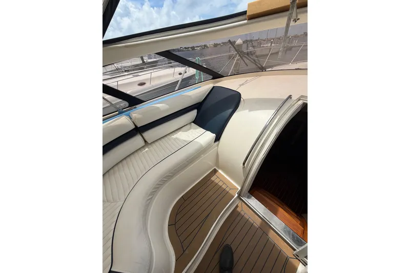 Slide: The Image of Interior view of 2003 Viking Princess V50 yacht with white seating and wooden flooring. - 19