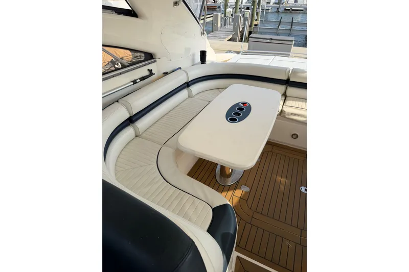 Slide: The Image of Luxurious seating area on a 2003 Viking Princess V50 yacht with elegant table and wood flooring. - 21