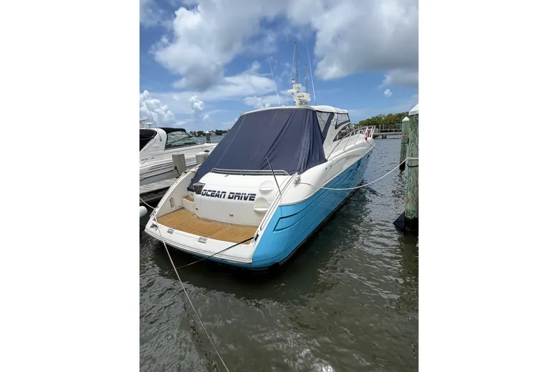 Slide: The Image of 2003 Viking Princess V50 yacht docked, featuring blue hull and covered deck. - 34