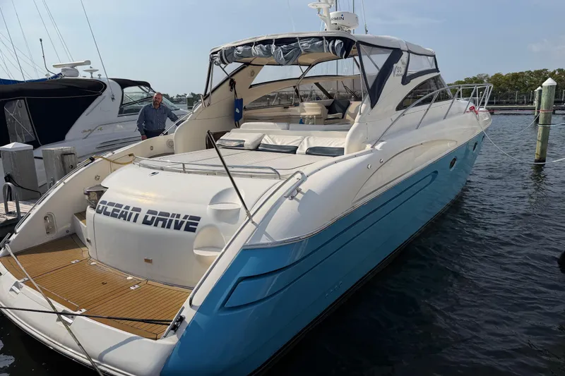 Slide: The Image of Luxury 2003 Viking Princess V50 yacht docked, featuring sleek design and spacious deck. - 35