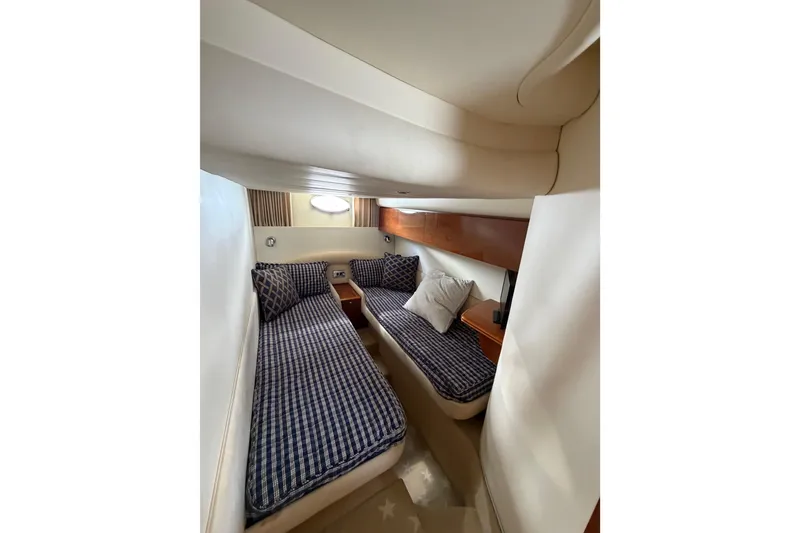Slide: The Image of Cozy cabin interior of 2003 Viking Princess V50 yacht with twin beds and nautical decor. - 4