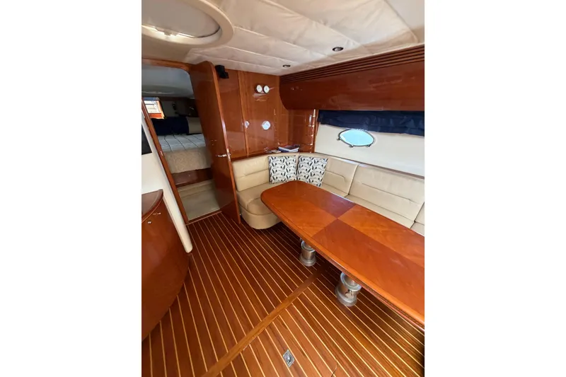 Slide: The Image of Luxurious 2003 Viking Princess V50 yacht interior with elegant wood finishes and cozy seating area. - 8