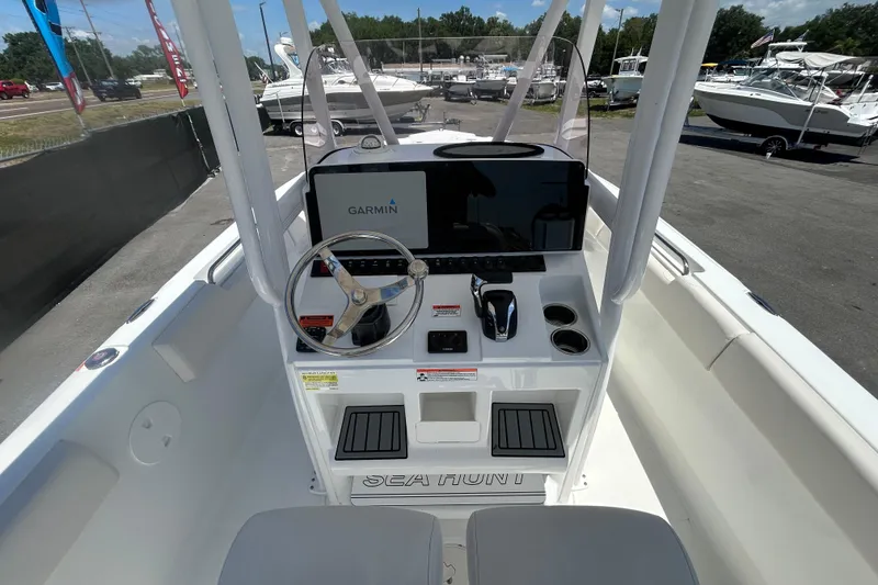 Slide: The Image of 2021 Sea Hunt Ultra 234 boat dashboard with Garmin navigation system and steering wheel. - 16