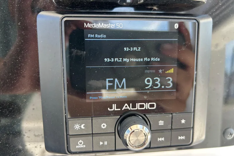 Slide: The Image of JL Audio MediaMaster 50 displaying FM radio station 93.3 FLZ on Sea Hunt Ultra 234. - 19
