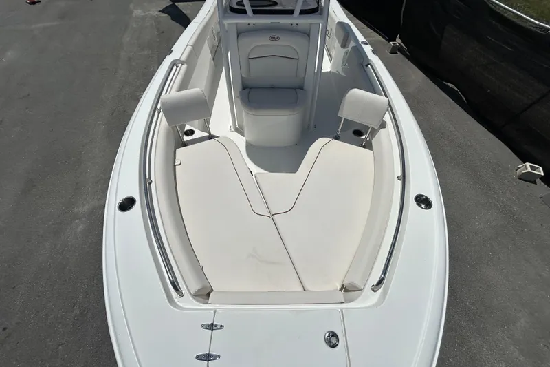 Slide: The Image of 2021 Sea Hunt Ultra 234 boat interior with cushioned seating and sleek design. - 28