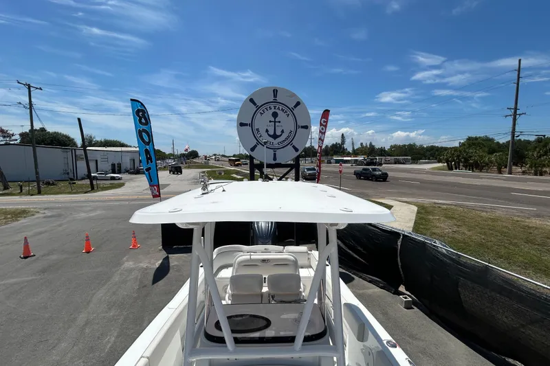 Slide: The Image of 2021 Sea Hunt Ultra 234 boat displayed outdoors with promotional flags and signage. - 30