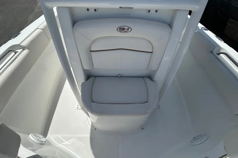 Slide: The Image of 2021 Sea Hunt Ultra 234 boat interior with white cushioned seating. - 31