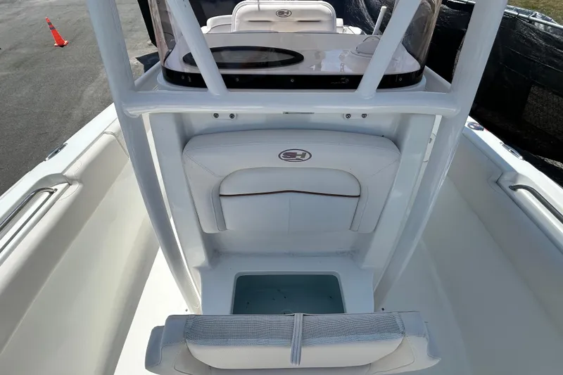 Slide: The Image of 2021 Sea Hunt Ultra 234 boat interior with seating and storage compartment. - 32