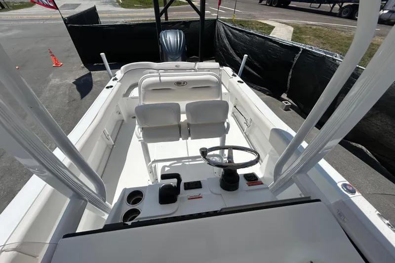 Slide: The Image of 2021 Sea Hunt Ultra 234 boat interior with dual seats and steering wheel. - 33