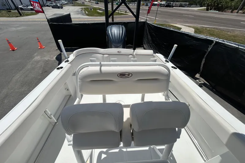 Slide: The Image of 2021 Sea Hunt Ultra 234 boat interior with seating and steering console. - 35