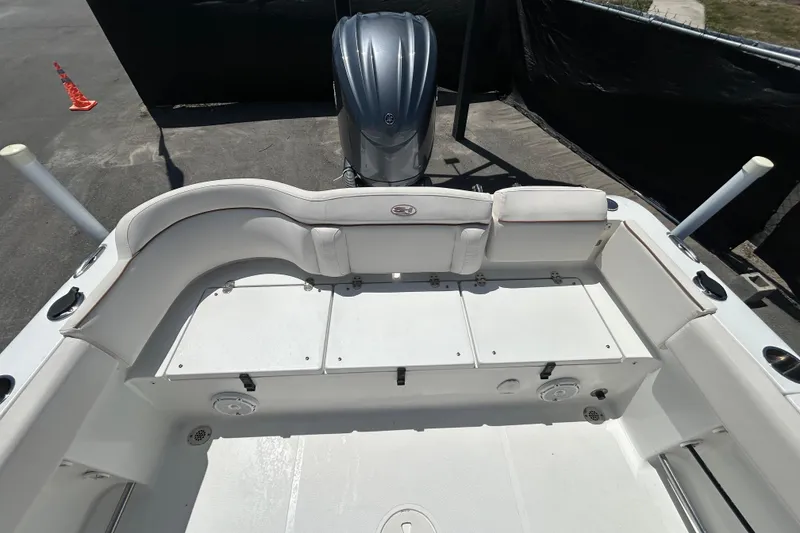 Slide: The Image of 2021 Sea Hunt Ultra 234 boat interior with seating and engine view. - 38