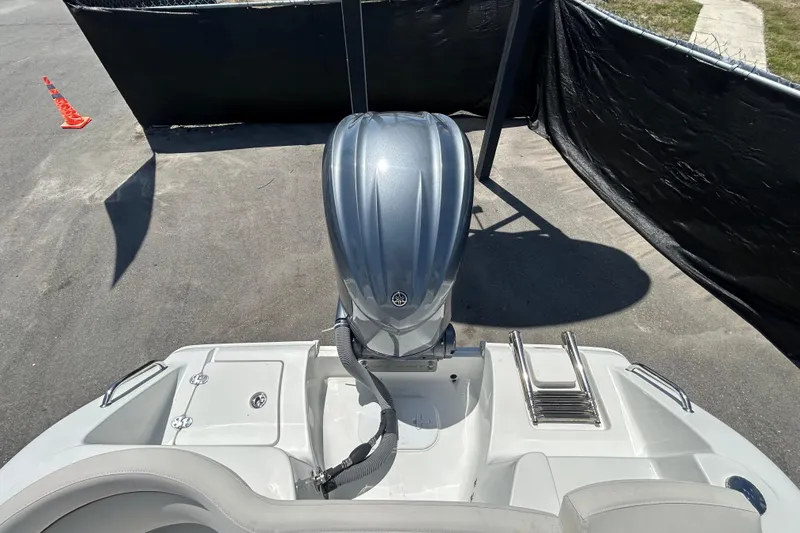 Slide: The Image of 2021 Sea Hunt Ultra 234 boat with outboard motor and swim ladder. - 41