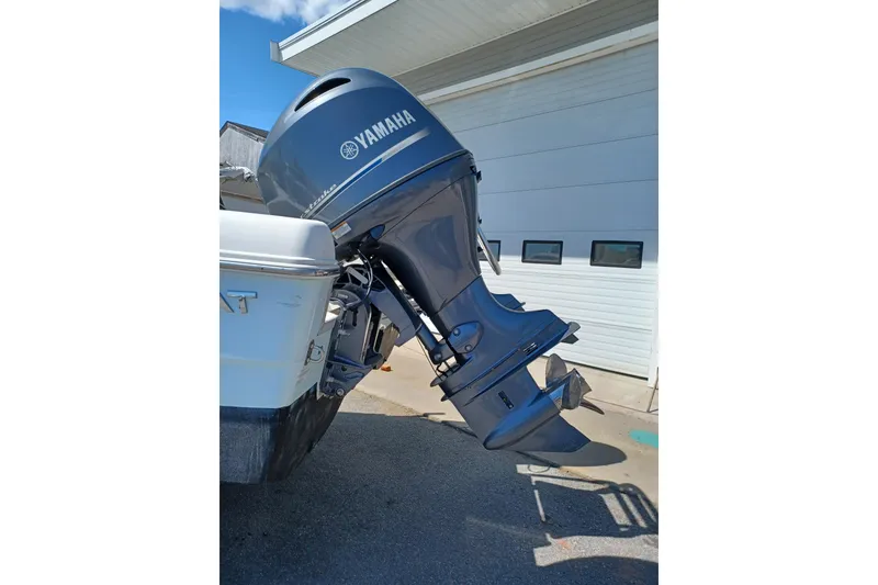 Slide: The Image of Yamaha outboard motor on a 2020 World Cat 230 DC boat, parked near a garage. - 21