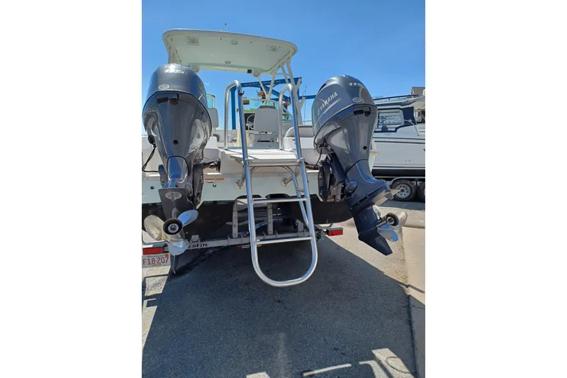 Slide: The Image of 2020 World Cat 230 DC boat with dual Yamaha outboard motors and ladder. - 23