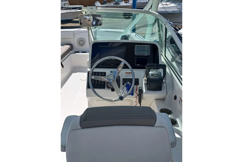 Slide: The Image of Cockpit of 2020 World Cat 230 DC boat with steering wheel and controls. - 25