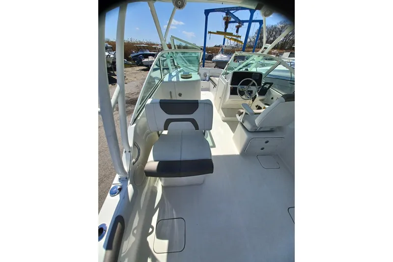 Slide: The Image of 2020 World Cat 230 DC boat interior with seating and steering wheel. - 26