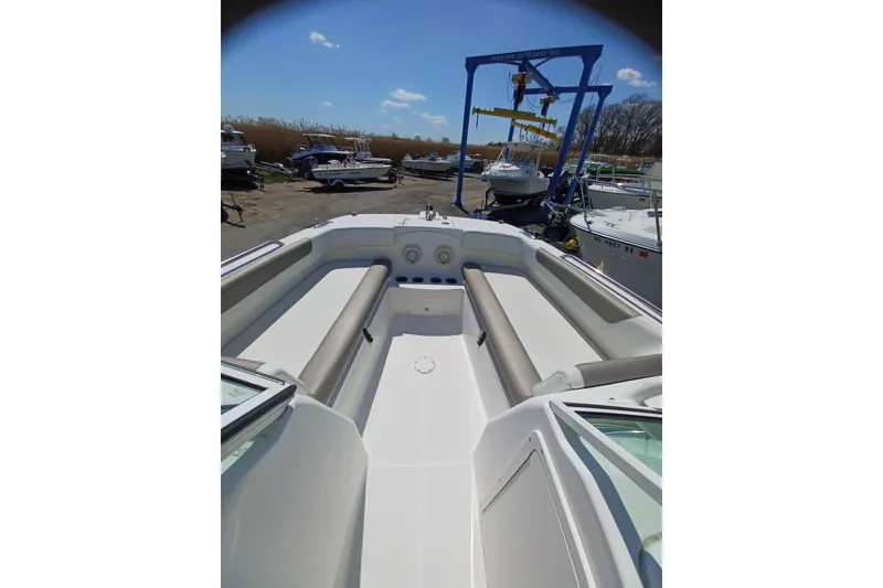 Slide: The Image of 2020 World Cat 230 DC boat interior with seating, docked outdoors. - 27