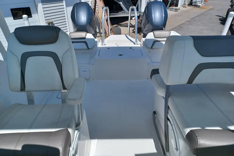 Slide: The Image of 2020 World Cat 230 DC boat interior with dual seating and twin engines. - 31