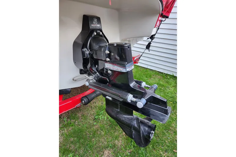 Slide: The Image of 2012 Rinker 216 Captiva Bowrider with MerCruiser outdrive on grass. - 2