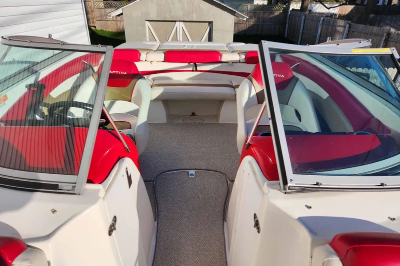 Slide: The Image of 2012 Rinker 216 Captiva Bowrider with red and white interior, open bow seating. - 3