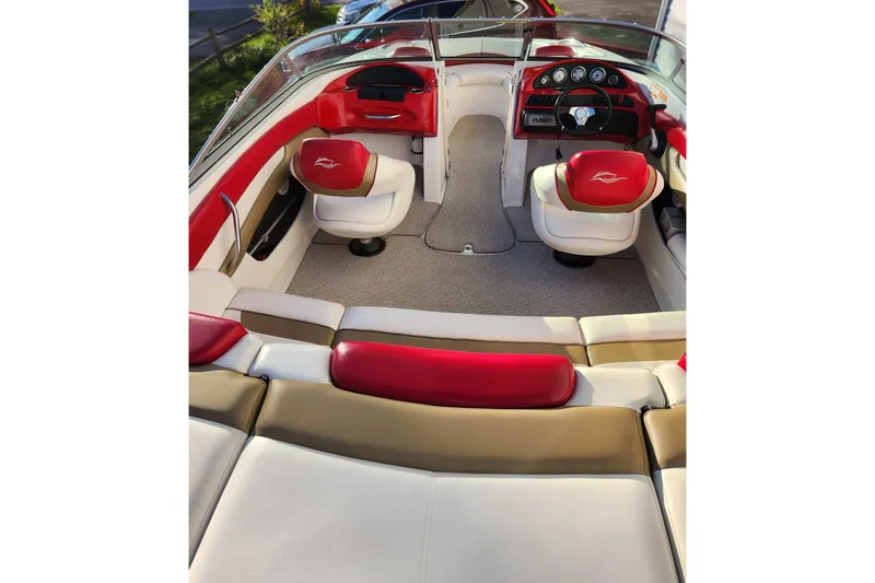 Slide: The Image of 2012 Rinker 216 Captiva Bowrider interior with red and white seating, dashboard view. - 6