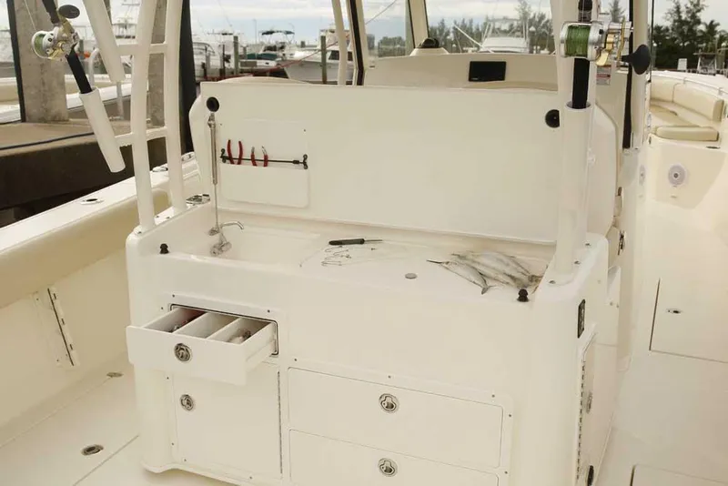 Slide: The Image of Manufacturer Provided Image: 2024 Cobia 350 Center Console fishing station with storage drawers and tools. - 11
