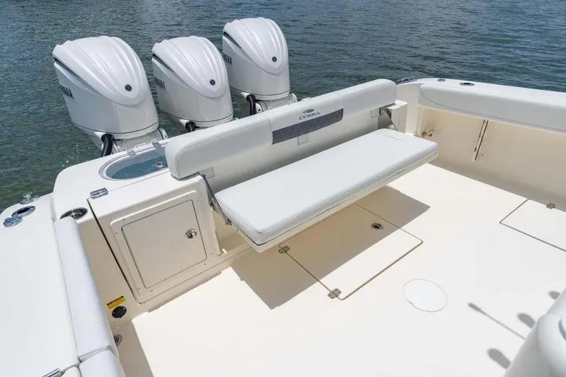 Slide: The Image of Manufacturer Provided Image: 2024 Cobia 350 Center Console boat with triple outboard engines and fold-down bench seat. - 16
