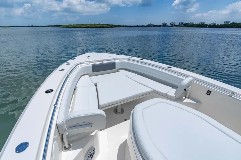 Slide: The Image of Manufacturer Provided Image: 2024 Cobia 350 Center Console boat with spacious seating on calm waters. - 2