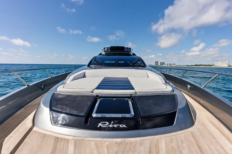 Slide: The Image of Luxurious 2021 Riva 66' Ribelle yacht cruising on open sea under blue sky. - 10
