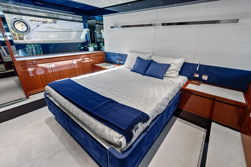 Slide: The Image of Luxurious bedroom interior of 2021 Riva 66' Ribelle yacht with elegant blue and white decor. - 16
