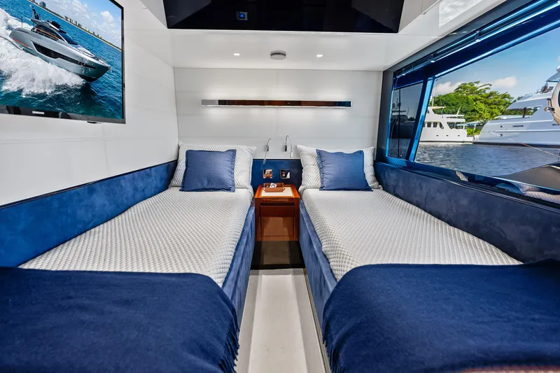 Slide: The Image of Luxurious interior of 2021 Riva 66' Ribelle yacht with twin beds and scenic window view. - 22