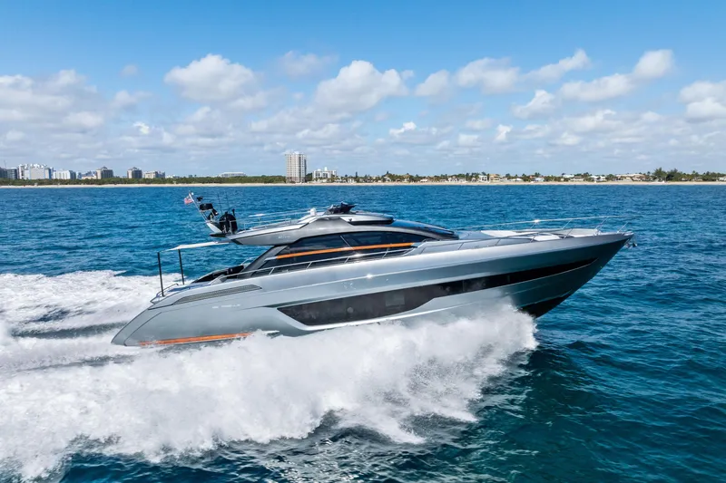 Slide: The Image of 2021 Riva 66' Ribelle yacht cruising on open sea under clear blue sky. - 26