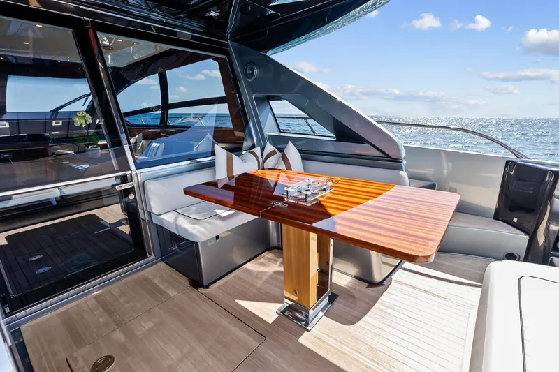 Slide: The Image of Luxurious 2021 Riva 66' Ribelle yacht interior with elegant dining area and ocean view. - 5