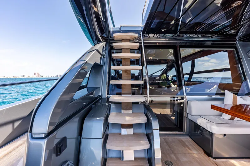 Slide: The Image of Luxurious interior of 2021 Riva 66' Ribelle yacht with modern staircase and seating area. - 7