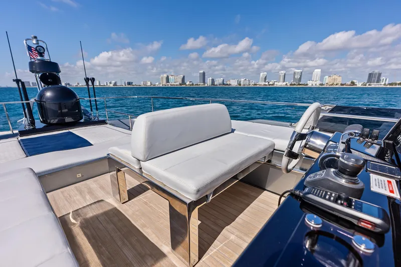 Slide: The Image of Luxurious 2021 Riva 66' Ribelle yacht with modern helm, ocean view, and city skyline. - 9