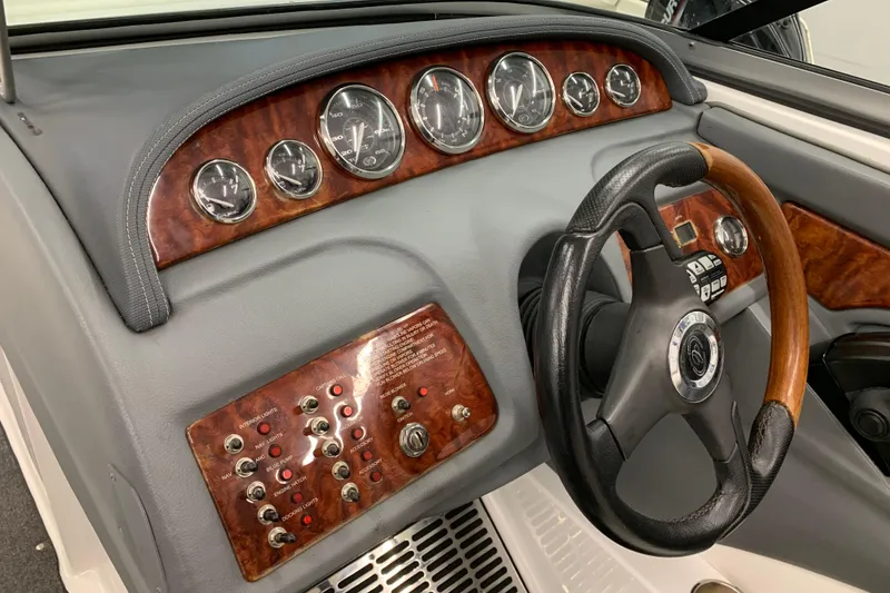 Slide: The Image of Dashboard of a 2007 Cobalt 262 boat with wood accents and gauges. - 10