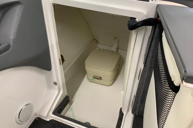 Slide: The Image of 2007 Cobalt 262 boat interior with portable toilet in storage compartment. - 12
