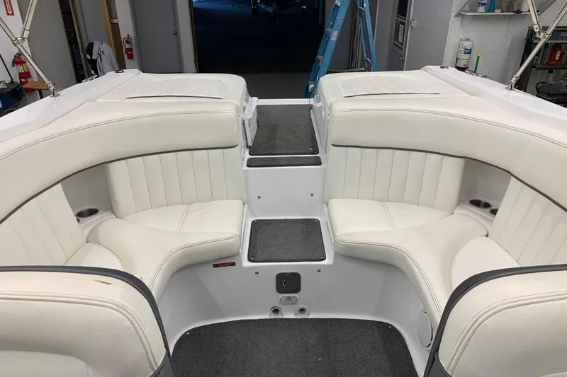 Slide: The Image of Interior of a 2007 Cobalt 262 boat with white cushioned seating and carpeted flooring. - 13