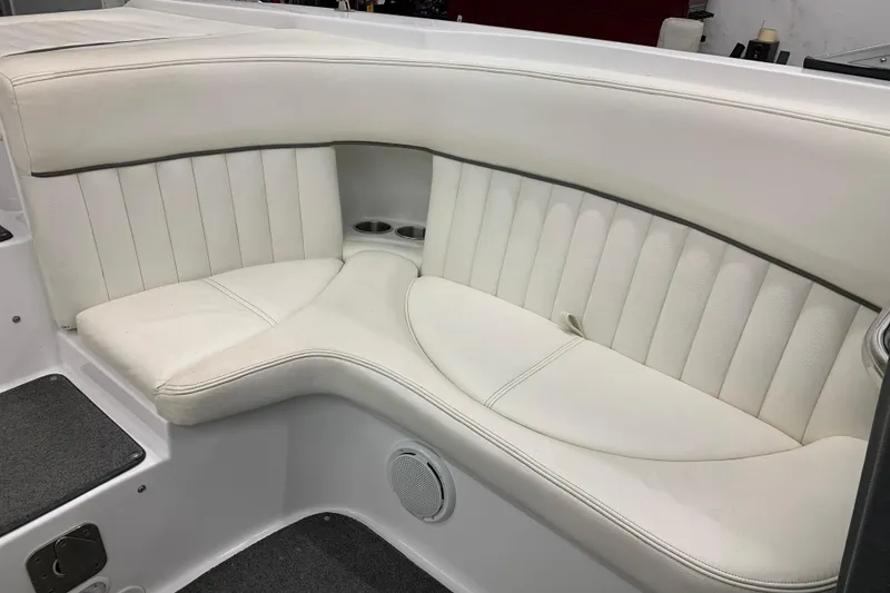 Slide: The Image of Luxurious white seating in a 2007 Cobalt 262 boat, featuring cup holders and speaker. - 14