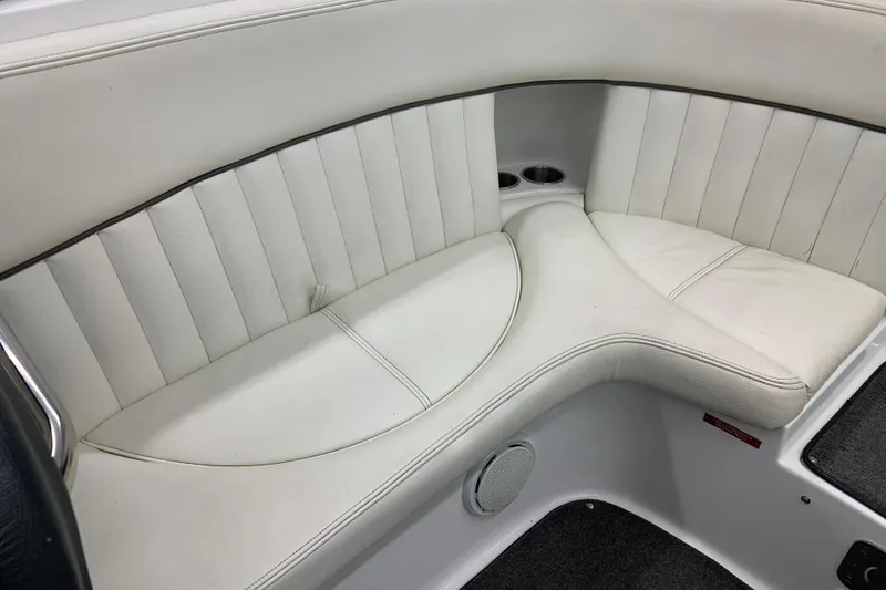 Slide: The Image of White leather seating in a 2007 Cobalt 262 boat, featuring cup holders and speaker. - 16