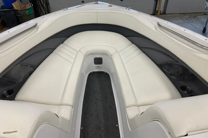 Slide: The Image of Interior of a 2007 Cobalt 262 boat with white seating and cup holders. - 19