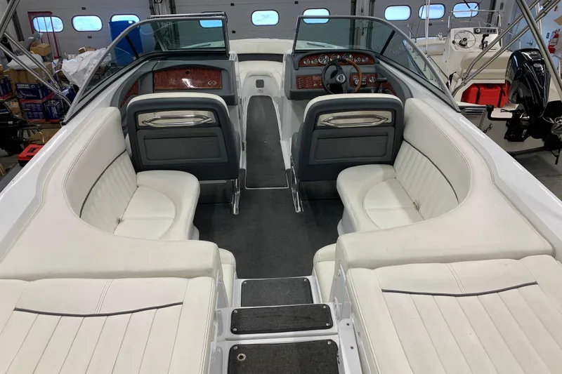 Slide: The Image of Interior view of a 2007 Cobalt 262 boat with white seating and dashboard. - 2