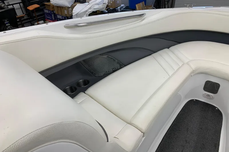 Slide: The Image of Interior of a 2007 Cobalt 262 boat with white seating and cup holders. - 22