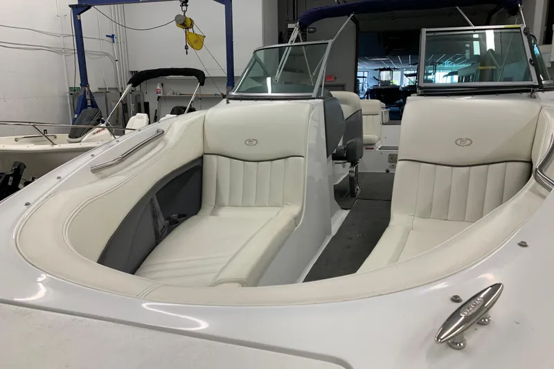 Slide: The Image of 2007 Cobalt 262 boat interior with white leather seating in a showroom. - 30