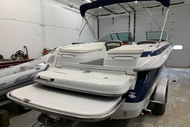 Slide: The Image of 2007 Cobalt 262 boat in a garage, featuring a sleek design and spacious deck. - 31