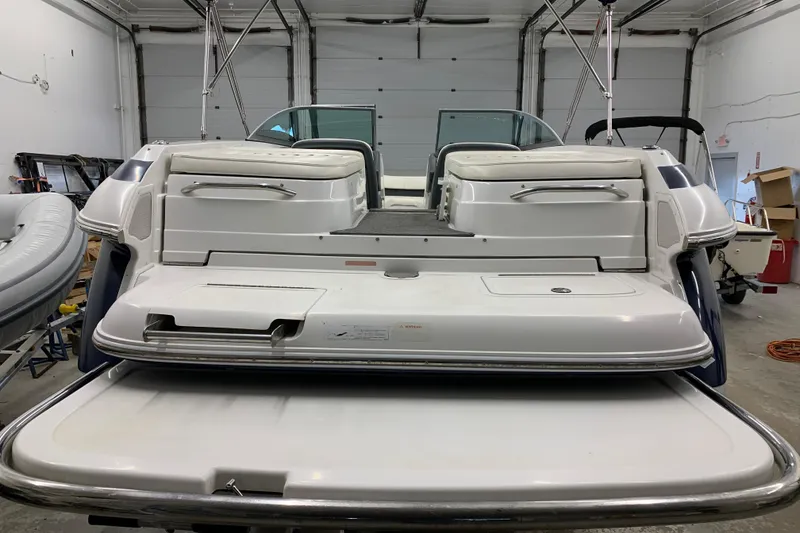 Slide: The Image of 2007 Cobalt 262 boat in a garage, showcasing rear seating and swim platform. - 32